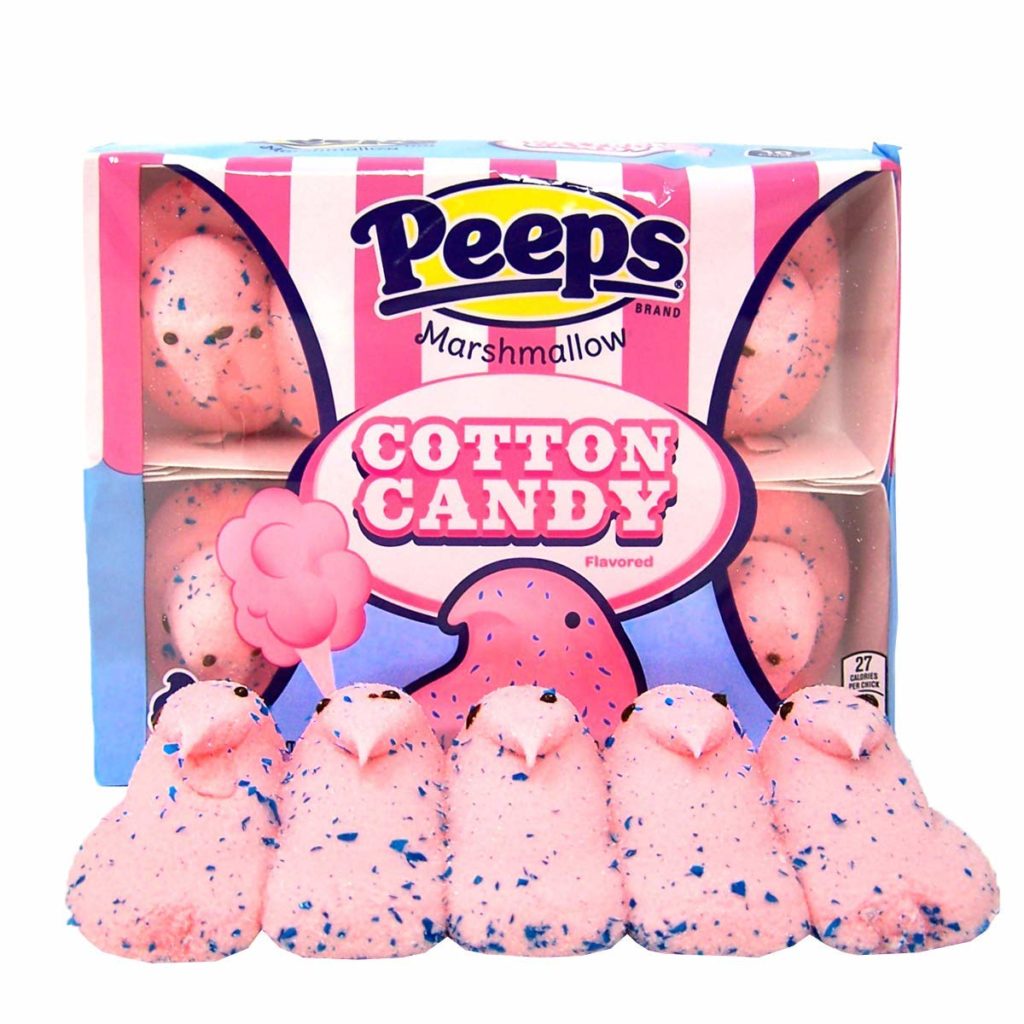 Pink and blue chick shaped marshmallow. Packaging behind with "Peeps" branding. 